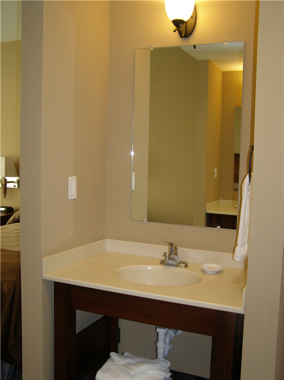 Rooms also include an in-room bathroom, and vanity sinks outside of the bathroom.